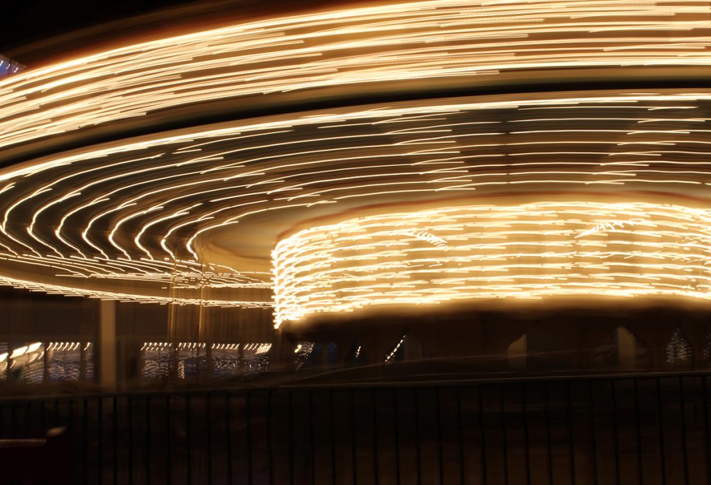 Timelapse photo of a carousel lit up.